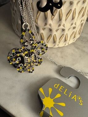 dELiA*s Fleur-de-Lis Crystal Pendant Necklace in Yellow, Green, Black